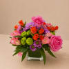 A vibrant and cheerful flower arrangement featuring a beautiful mix of pink