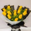 Bouquet of yellow roses wrapped in black and white paper