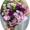 Soft pink daisies and pale pink carnations meet pops of vivid purple
