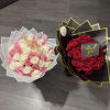 Two rose bouquets, one pink and white and one red, wrapped in decorative paper