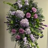 Tall standing floral spray with pink roses and lavender blooms