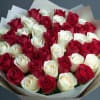 Bouquet of red and white roses wrapped in paper