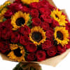Bouquet of red roses and yellow sunflowers wrapped in brown paper