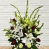 White lilies and burgundy roses in a decorative vase