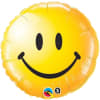 Yellow smiley face foil balloon on a white background