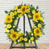 Yellow floral wreath on a black easel stand