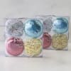 Two clear gift boxes of assorted frosted cookies in pastel colors tied with silver string