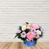 A dainty and sweet floral arrangement in a blue toned hydrangea teacup