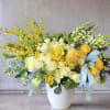 This stunning arrangement radiates happiness with a blend of sun-kissed yellow, crisp