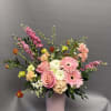 A soft and cheerful mix of blush pink, peach, and creamy blooms