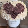 Bouquet of white and mauve roses in a white hatbox