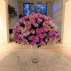 Large pink and white floral arrangement in a clear glass vase