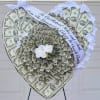 Heart-shaped money bouquet with white ribbon and small white flowers
