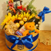 A charming gift box featuring a tractor-themed topper, bright sunflowers, Ferrero Rocher