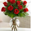 Red roses arranged in a clear glass vase