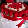 Round box of red and white roses tied with a red ribbon