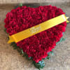 Heart-shaped red carnation arrangement with a yellow ribbon reading Dad