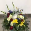 Low floral arrangement with red roses, yellow lilies, and white hydrangeas