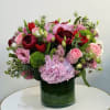 This elegant spring floral arrangement is thoughtfully designed with a premium selection
