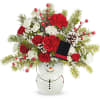 Holiday bouquet in a snowman vase with red and white flowers