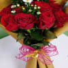Tightly clustered red roses take center stage in this one dozen red