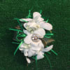 White orchid corsage with green ribbon and jeweled center