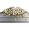 White casket spray with pale pink flowers