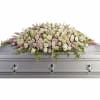 Pastel rose casket spray on a silver casket
