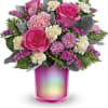 Pink and white flower arrangement in a pink iridescent vase