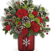 Christmas bouquet in a red vase with pinecones and red flowers