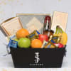 Gift basket with fruit, chocolates, cookies, and a bottle in a black box