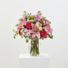 Pink lilies and vivid pink roses take center stage in this Luxe