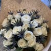 Bouquet of white roses with dark blue thistle-like accents