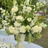 Overflowing white hydrangeas with extra seasonal stems and larger-scale styling for maximum