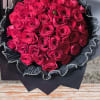 Bouquet of hot pink roses wrapped in black paper