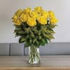Yellow roses arranged in a clear glass vase