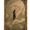 Fringed memorial tapestry with a figure standing in clouds and script text