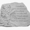 Stone memorial plaque with an engraved leaf and farewell quote