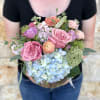 A soft and delicate English garden style arrangement in shades of cream