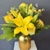 Bright yellow Asiatic lilies take center stage in this sunny flower arrangement