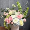 Pink and white roses with ranunculus in a white vase