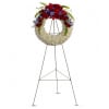 Standing floral wreath with red, white, and blue flowers on an easel
