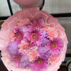 Pink and lavender bouquet with gerbera daisies and carnations wrapped in pink paper