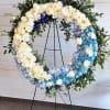 A thoughtfully designed standing wreath that offers a meaningful expression of love
