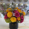 Yellow and pink roses arranged in a black hat box