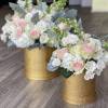 Two pastel rose arrangements in gold boxes