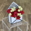 Small box arrangement of red and white roses with carnations