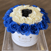 Round box of blue, white, and black roses