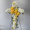 White and yellow floral cross on a stand