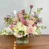 Pink and white floral arrangement in a clear glass vase